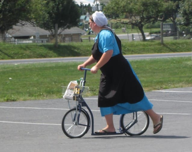 An Amish woman, wearing her required “modest” dress, on a scooter in Lancaster, Pennsylvania.